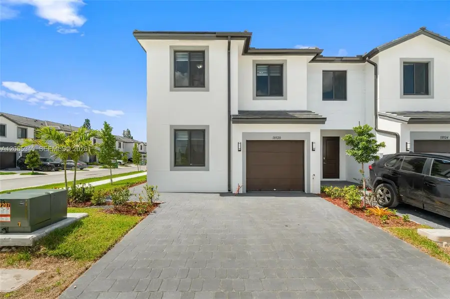 Front exterior of a new home in , Homestead, FL, highlighting curb appeal (Image 1). Front exterior of a new home in , Homestead, FL, highlighting curb appeal (Image 1).