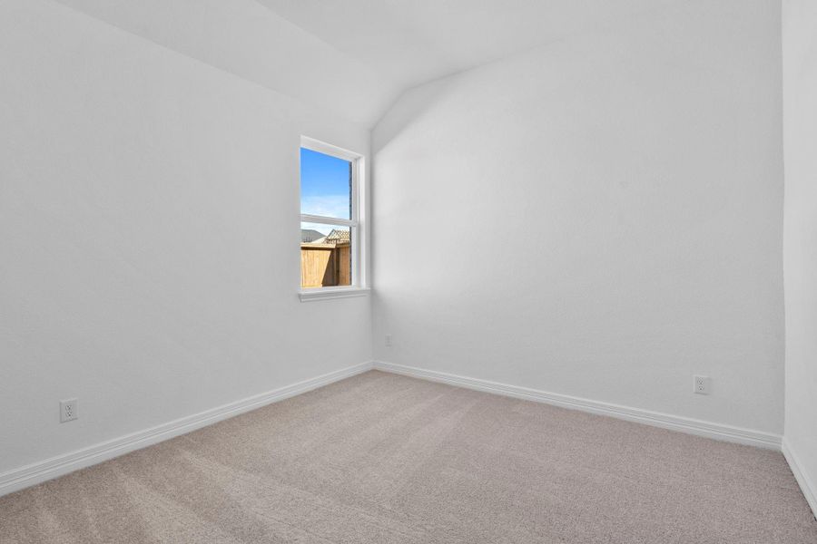 Your secondary bedroom features plush carpet, fresh paint, closet, and a large window that lets in plenty of natural lighting.