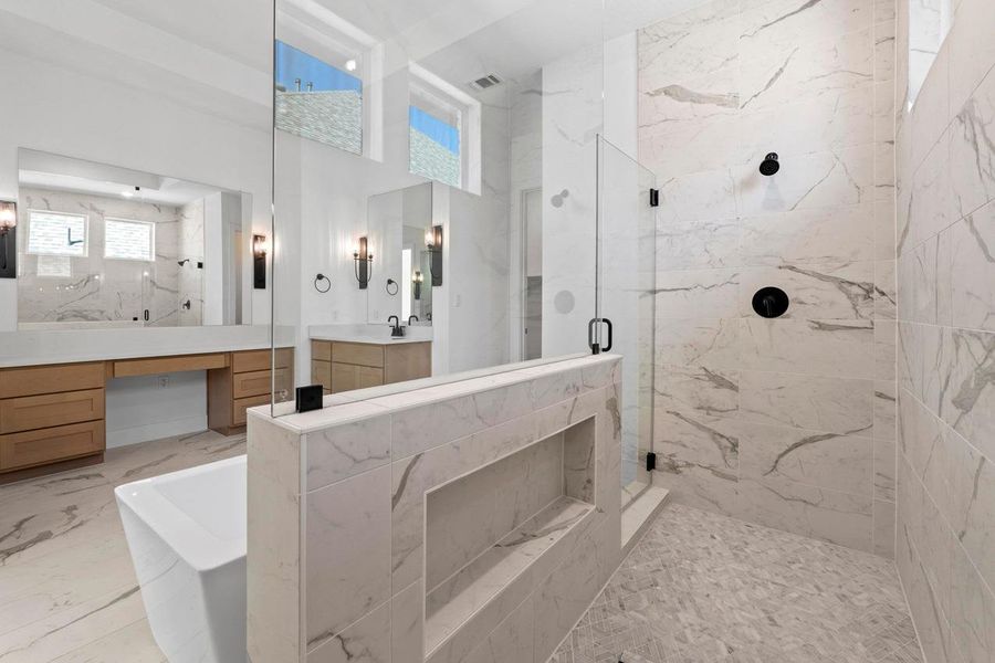 Bathroom with a marble finish shower, a freestanding tub, vanity, and marble finish flooring Bathroom with a marble finish shower, a freestanding tub, vanity, and marble finish flooring