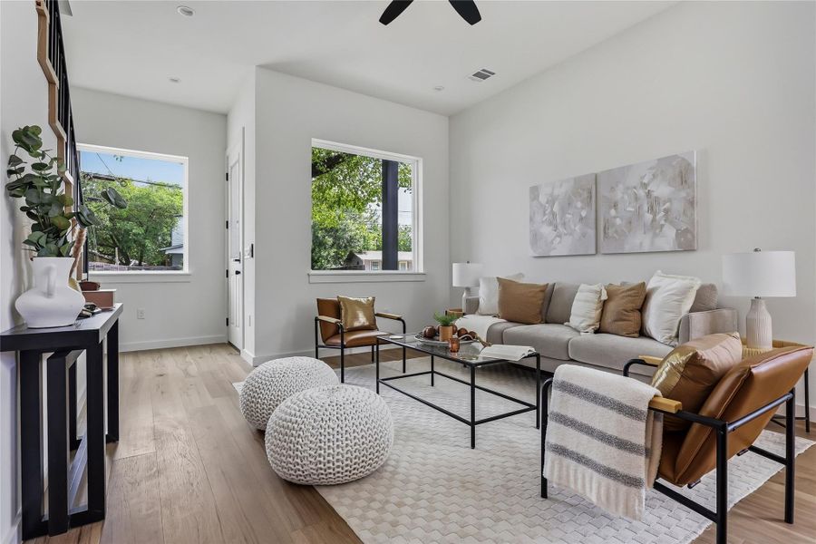 The large windows flood the living room with natural light.