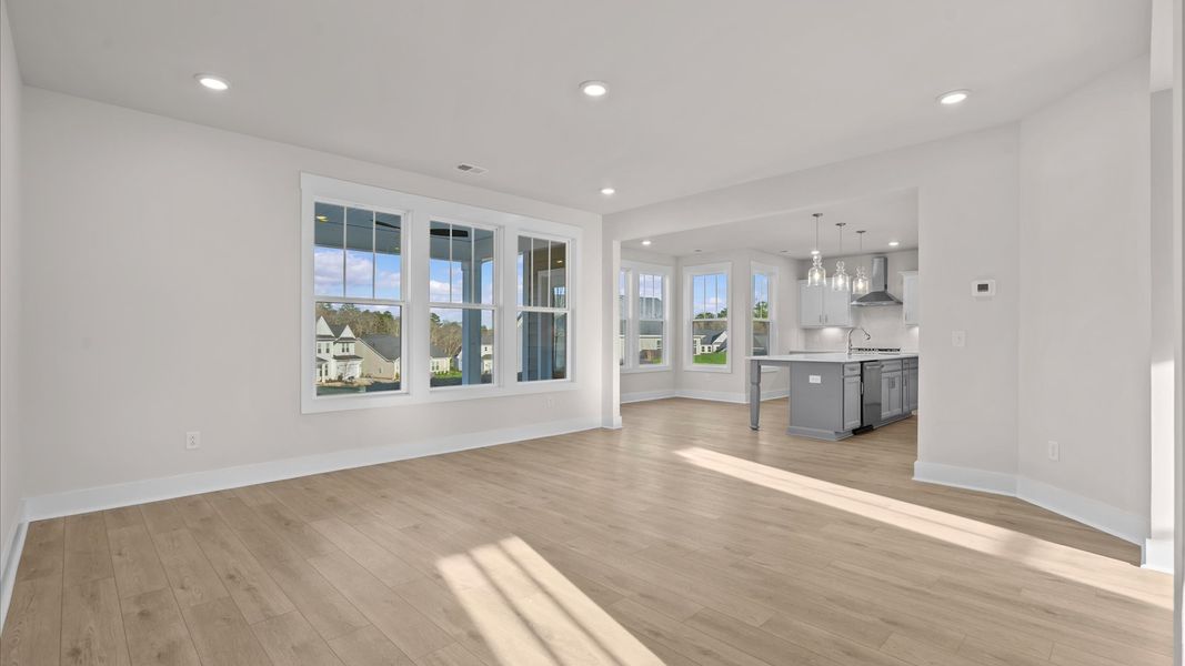 Eye-catching family room with elegant millwork and seamless access to dining and kitchen