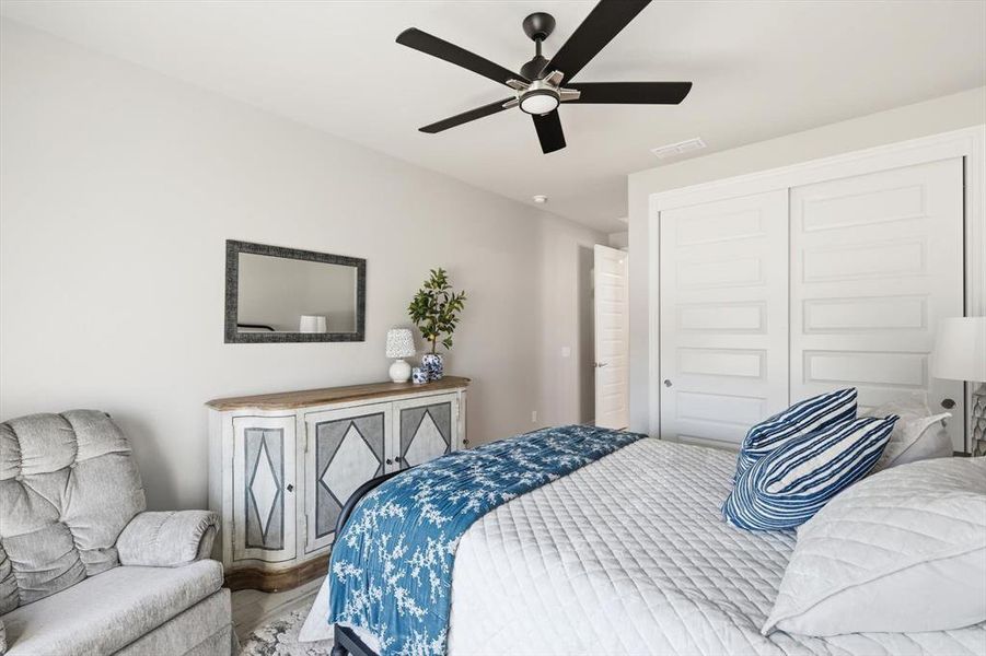 Bedroom featuring a closet, ceiling fan, and wood finished floors