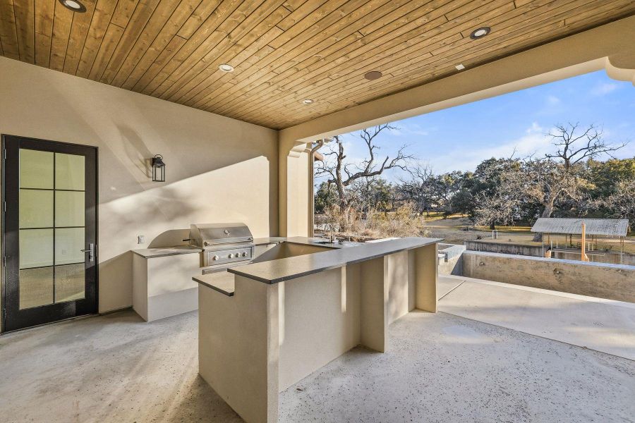 View of patio / terrace featuring an outdoor kitchen and a sink