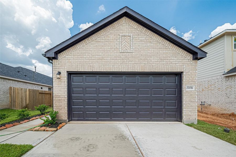 Front exterior of a new home in Woodland Lakes, Huffman, TX, highlighting curb appeal (Image 19). Front exterior of a new home in Woodland Lakes, Huffman, TX, highlighting curb appeal (Image 19).