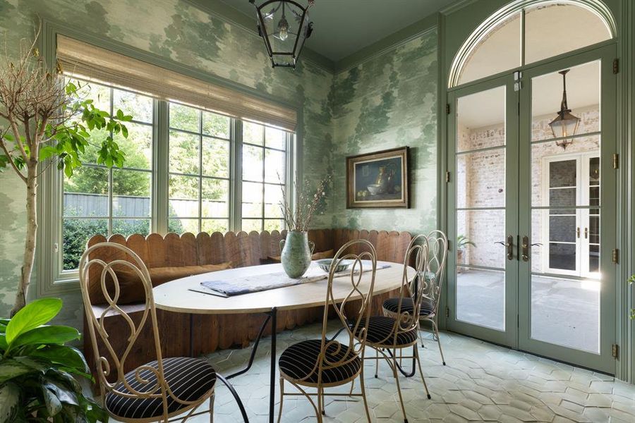 Sunroom featuring healthy amount of natural light and french doors