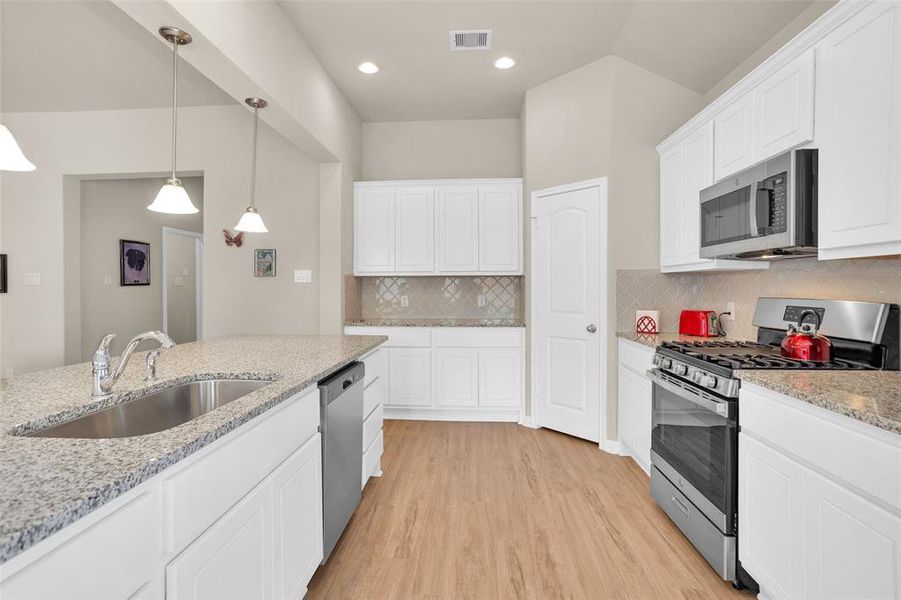 Kitchen with gas cooking and granite countertops