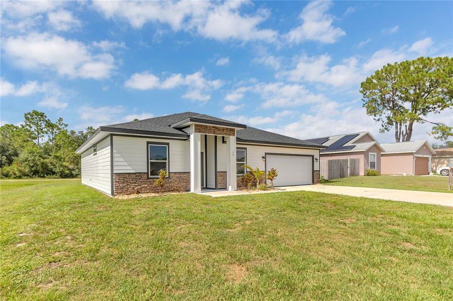 Front exterior of a new home in , Kissimmee, FL, highlighting curb appeal (Image 2).