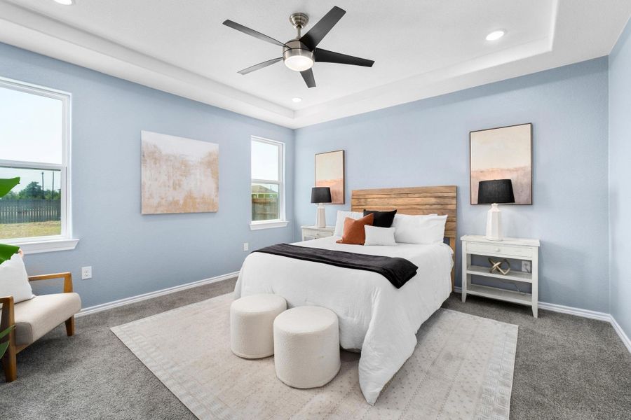 Bedroom with carpet floors, a raised ceiling, ceiling fan, and recessed lighting Bedroom with carpet floors, a raised ceiling, ceiling fan, and recessed lighting