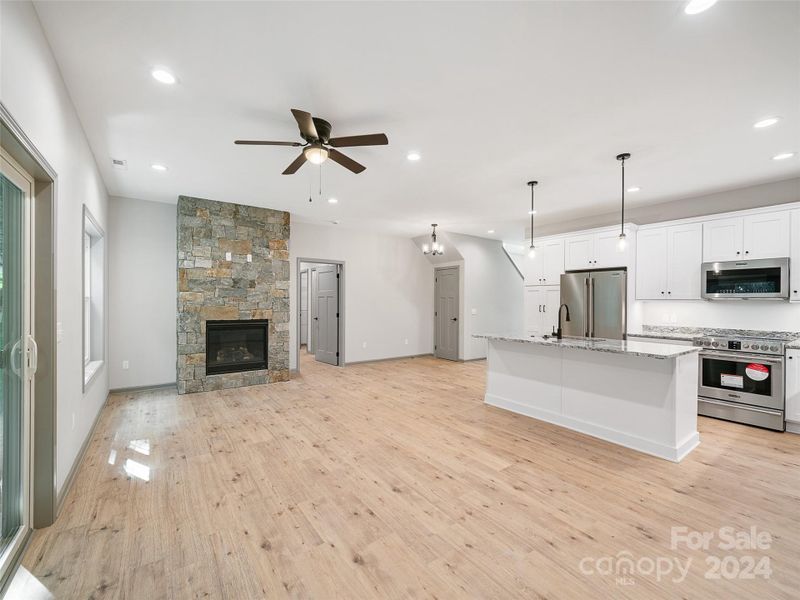 Open Floor plan Large great room and kitchen, natural vented gas fireplace with rockwork and tv and power connection within Open Floor plan Large great room and kitchen, natural vented gas fireplace with rockwork and tv and power connection within