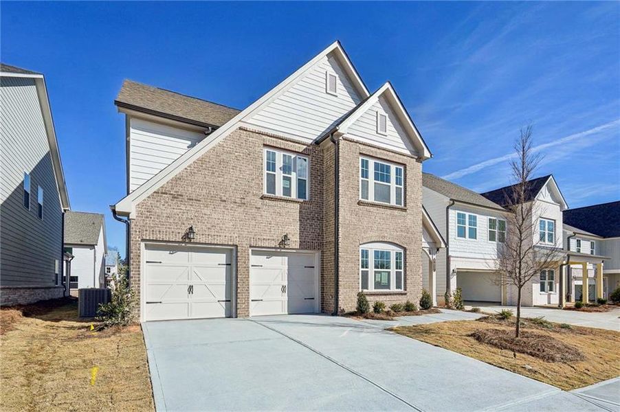 Front exterior of a new home in Eastlyn Crossing - Single Family, Flowery Branch, GA, highlighting curb appeal (Image 1). Front exterior of a new home in Eastlyn Crossing - Single Family, Flowery Branch, GA, highlighting curb appeal (Image 1).