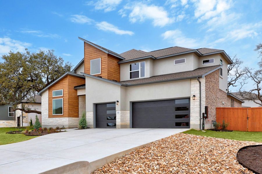 Front exterior of a new home in Caliterra, Dripping Springs, TX, highlighting curb appeal (Image 20).