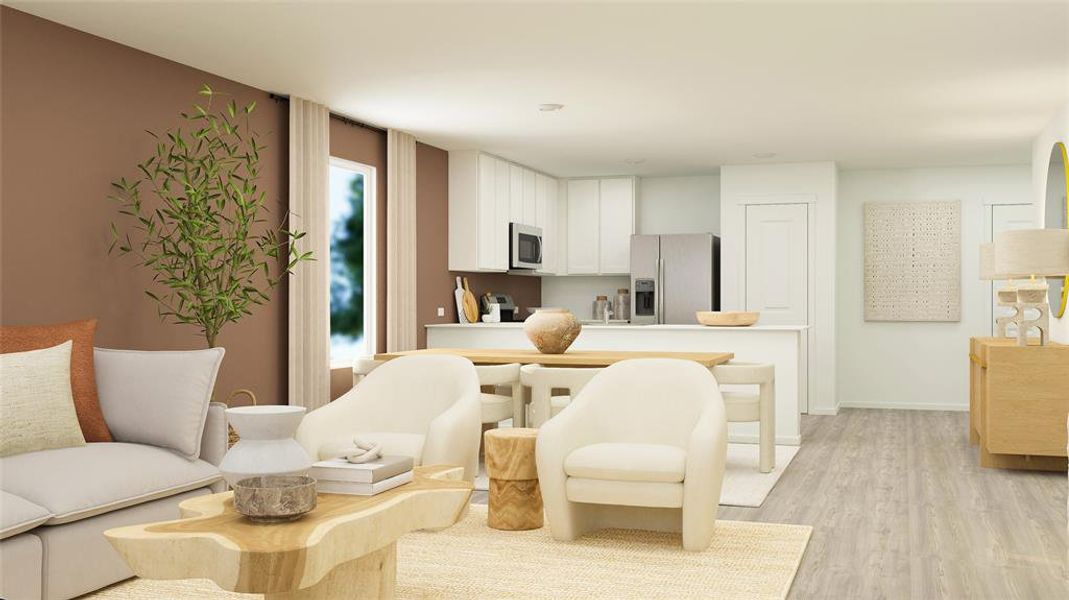 Kitchen featuring light countertops, appliances with stainless steel finishes, white cabinets, light wood-type flooring, and baseboards