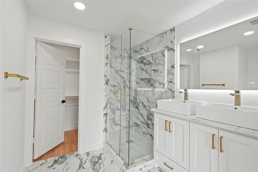 Bathroom featuring vanity and a shower with shower door