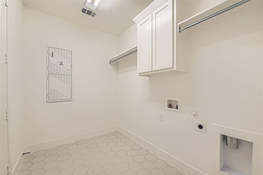 Laundry room with washer hookup, cabinet space, hookup for an electric dryer, and baseboards Laundry room with washer hookup, cabinet space, hookup for an electric dryer, and baseboards