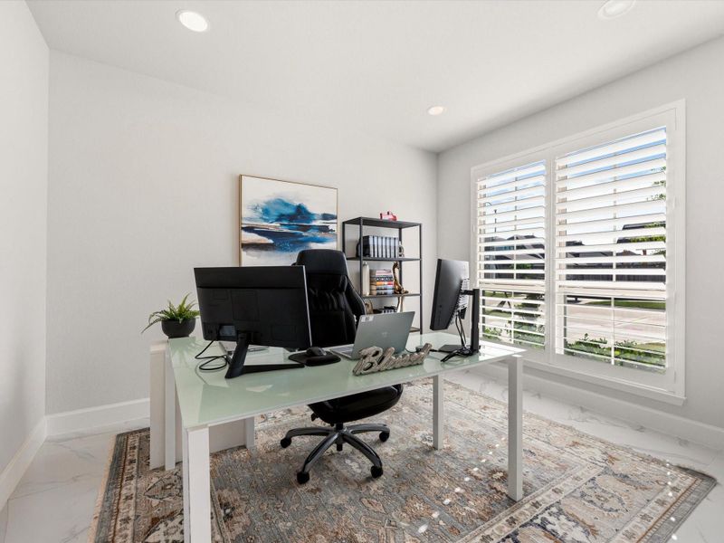 Spacious home office with plenty of sunlight but plantation shutters to close to minimize monitor glare.