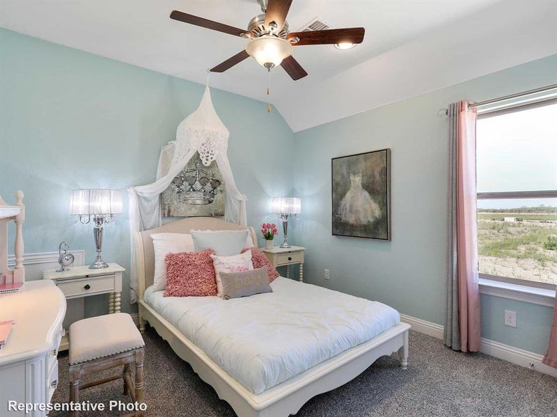 Bedroom with vaulted ceiling, ceiling fan, and carpet