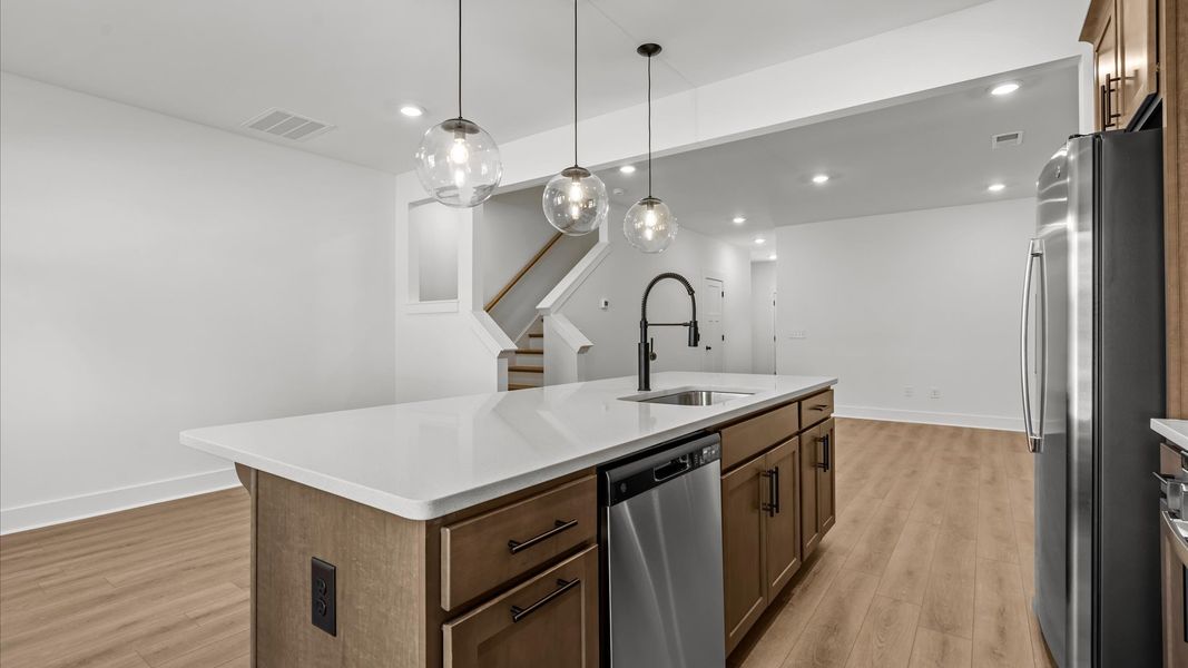 Notable 9-foot island provides generous prep and gathering space in this thoughtfully designed kitchen