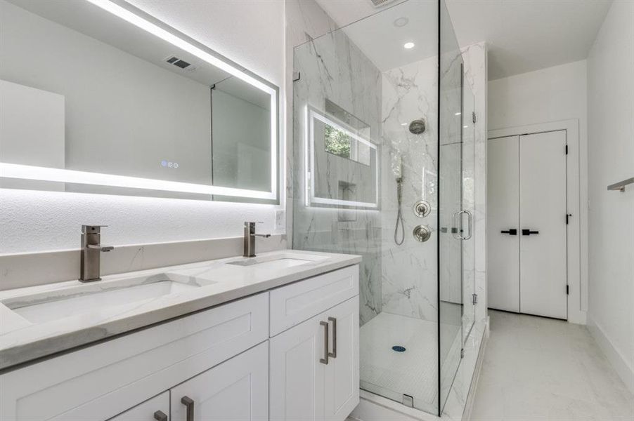 Bathroom with a marble finish shower and double vanity Bathroom with a marble finish shower and double vanity