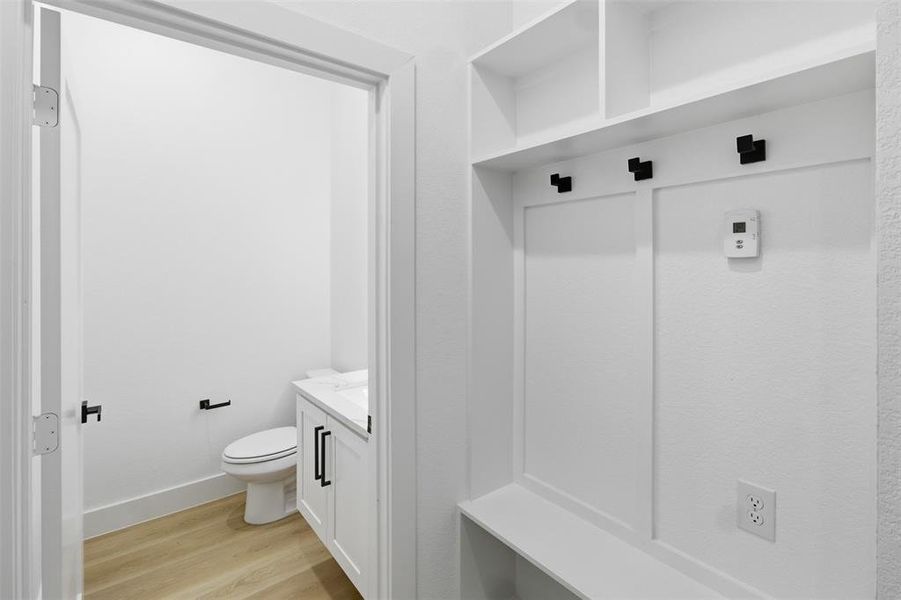 Mudroom featuring light wood-style floors and baseboards