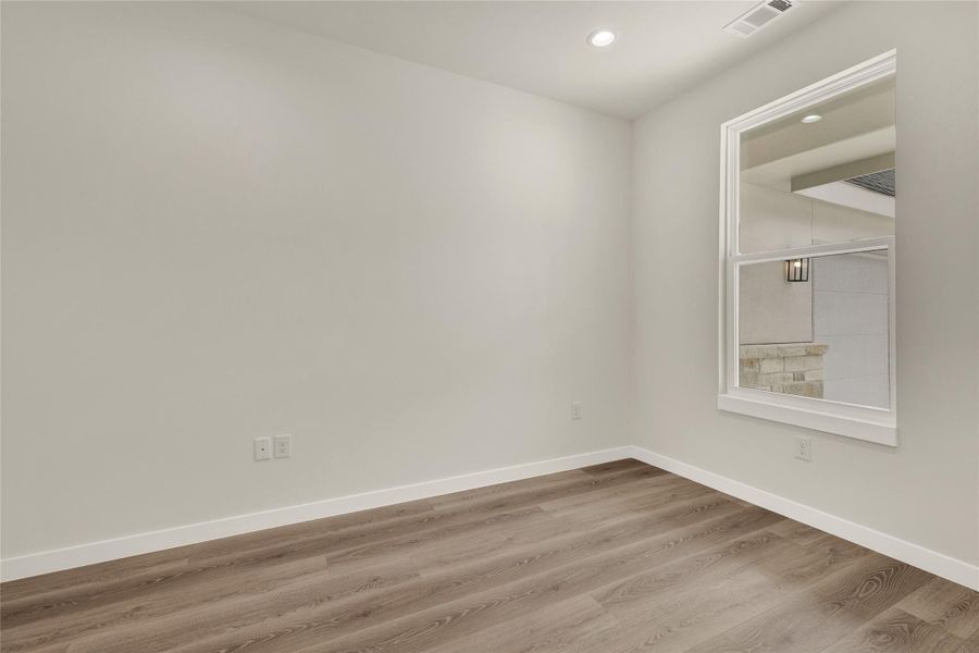 Unfurnished room featuring wood finished floors and recessed lighting