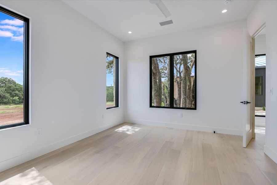 Naturally illuminated interiors boast light hardwood flooring and expansive windows with picturesque outdoor views.