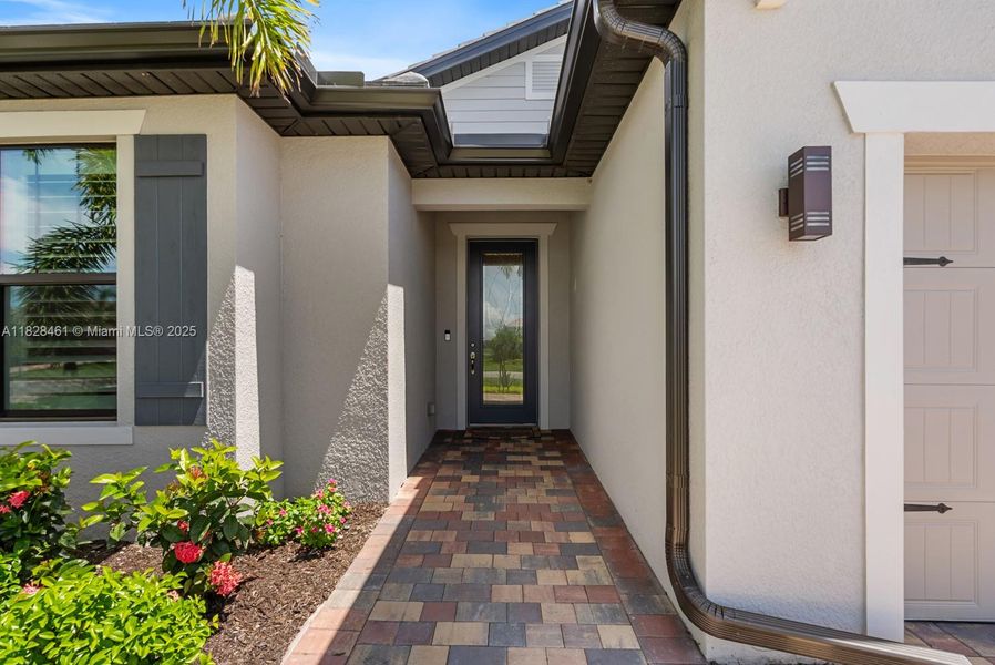 Front exterior of a new home in Del Webb Naples, Ave Maria, FL, highlighting curb appeal (Image 22).