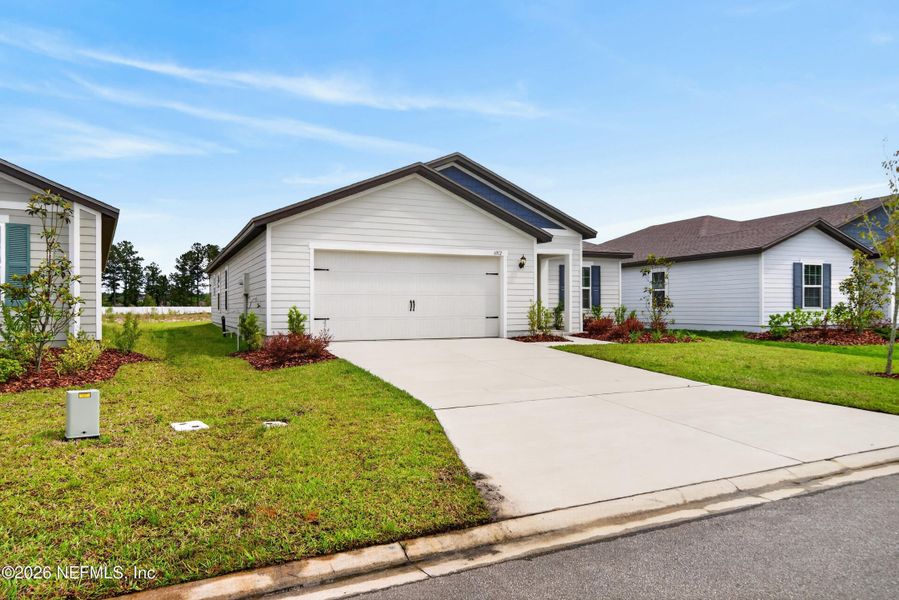Front exterior of a new home in Westport Landing, Jacksonville, FL, highlighting curb appeal (Image 21).