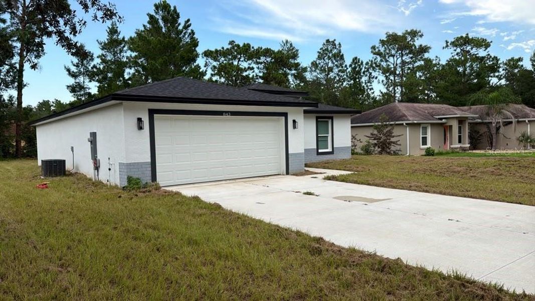 Front exterior of a new home in , Dunnellon, FL, highlighting curb appeal (Image 2). Front exterior of a new home in , Dunnellon, FL, highlighting curb appeal (Image 2).