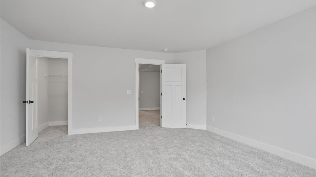 Memorable space with walk-in closet, soft carpeting, and striking natural light from large windows Memorable space with walk-in closet, soft carpeting, and striking natural light from large windows