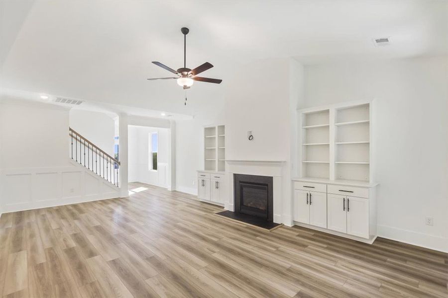 Gleaming wood floors and customized built-ins anch