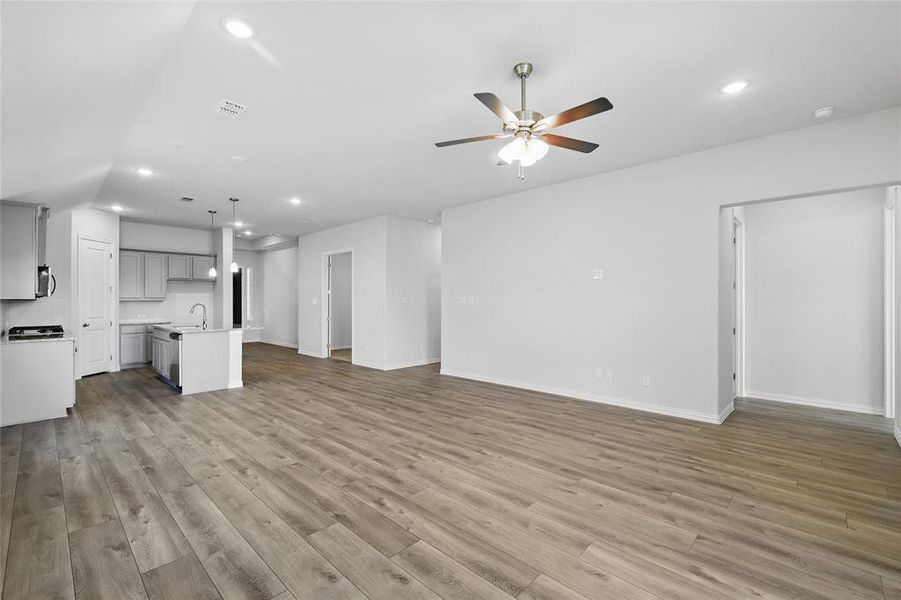 Unfurnished living room featuring recessed lighting, ceiling fan, and light wood-style flooring