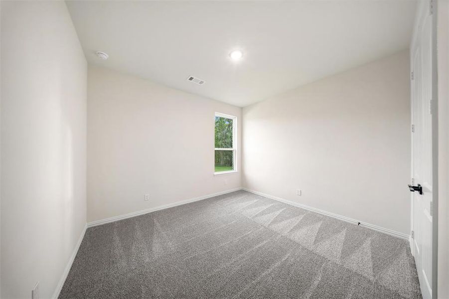Carpeted empty room featuring baseboards and recessed lighting
