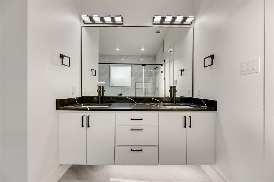 Full bath featuring double floating vanity