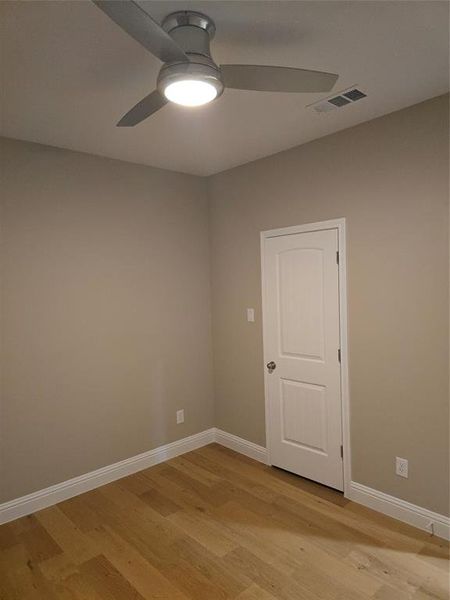 Empty room with light wood-type flooring and ceiling fan