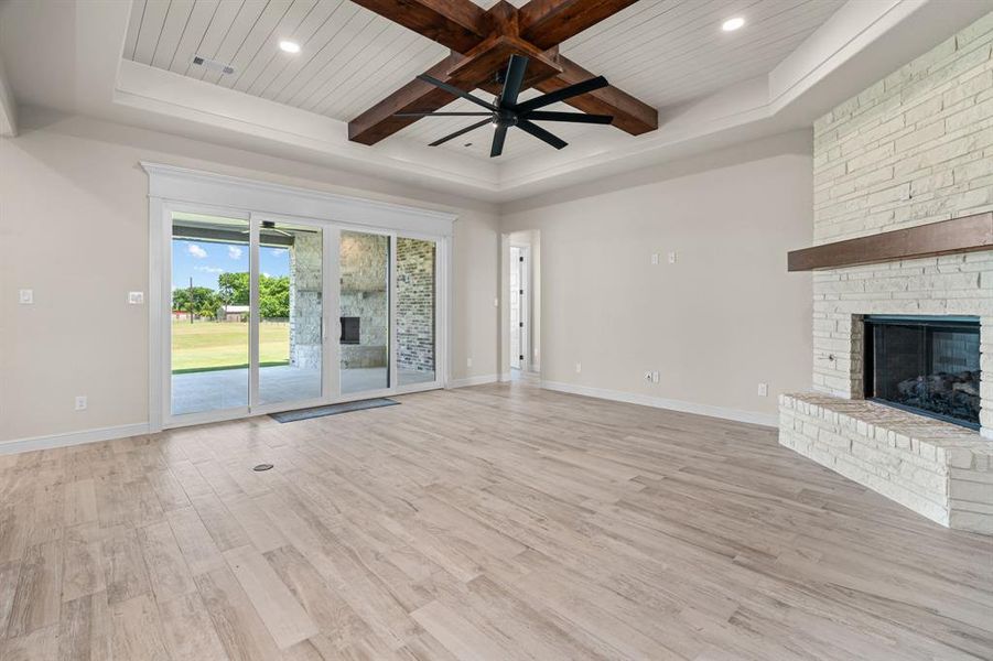 Spacious Living Room offers a Gas Fireplace, Wood Beamed Ceiling & Great Covered Patio Access