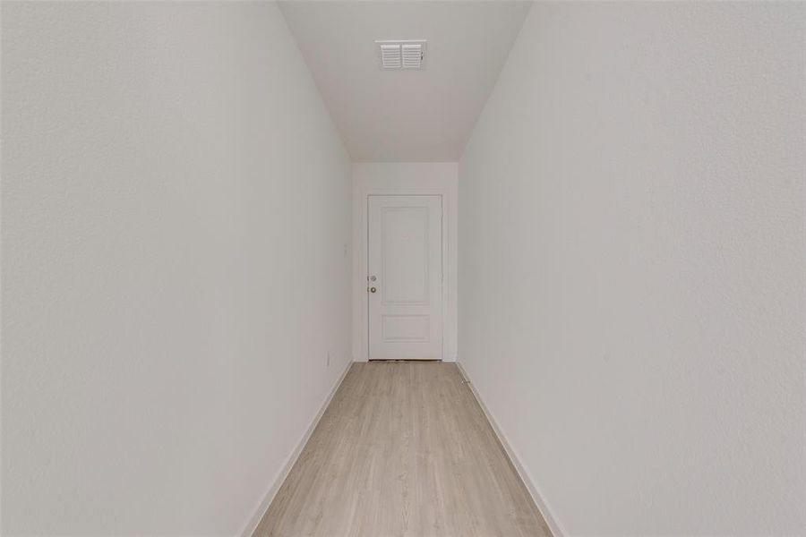 Hallway with light wood-type flooring