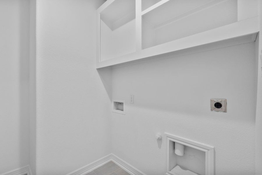 The utility room is both functional and refined, designed to support daily routines with ease.