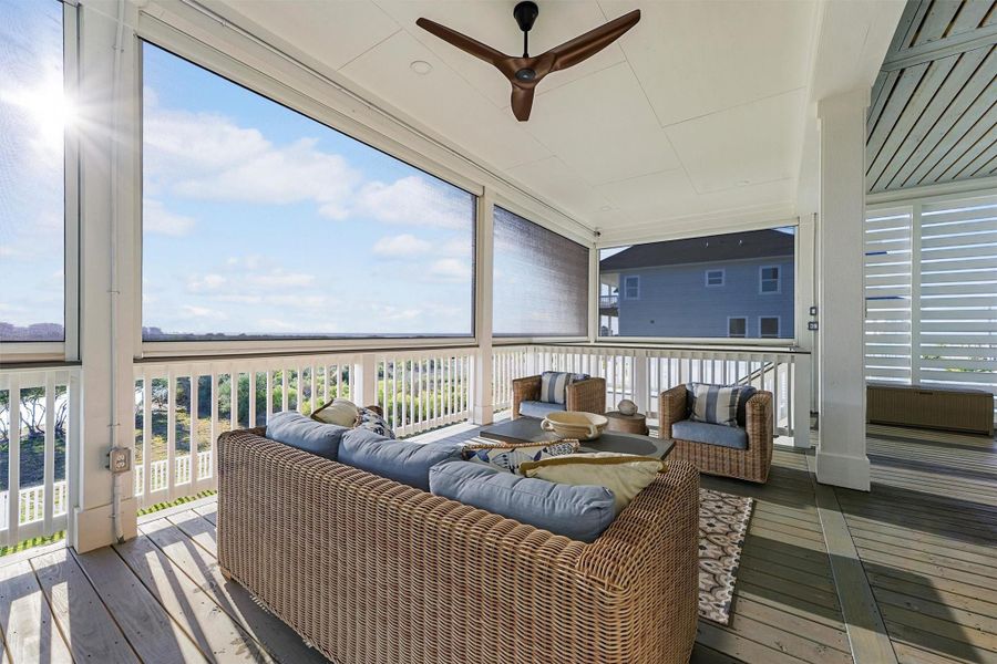 Cozy screened porch seating area is the perfect location to read your favorite book.
