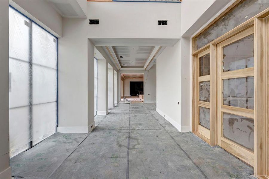 View from the front entrance into this home. Doors on the left lead to the study. Stage of construction as of April 3, 2025. View from the front entrance into this home. Doors on the left lead to the study. Stage of construction as of April 3, 2025.