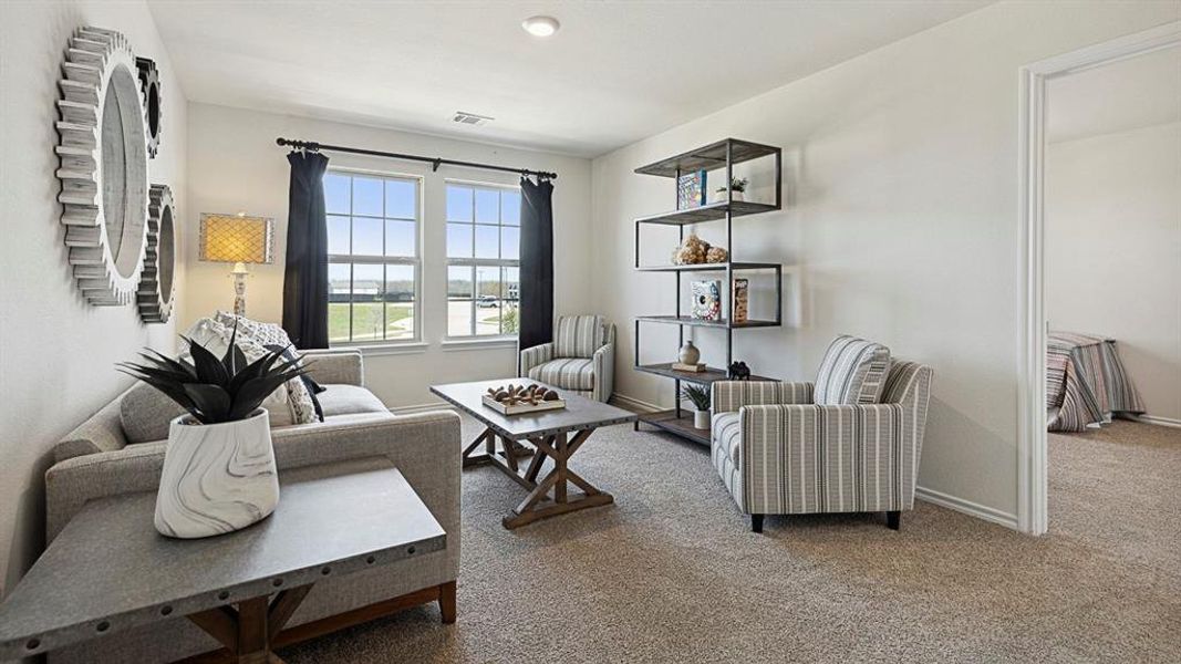Living area featuring carpeted flooring and two windows with dark curtains