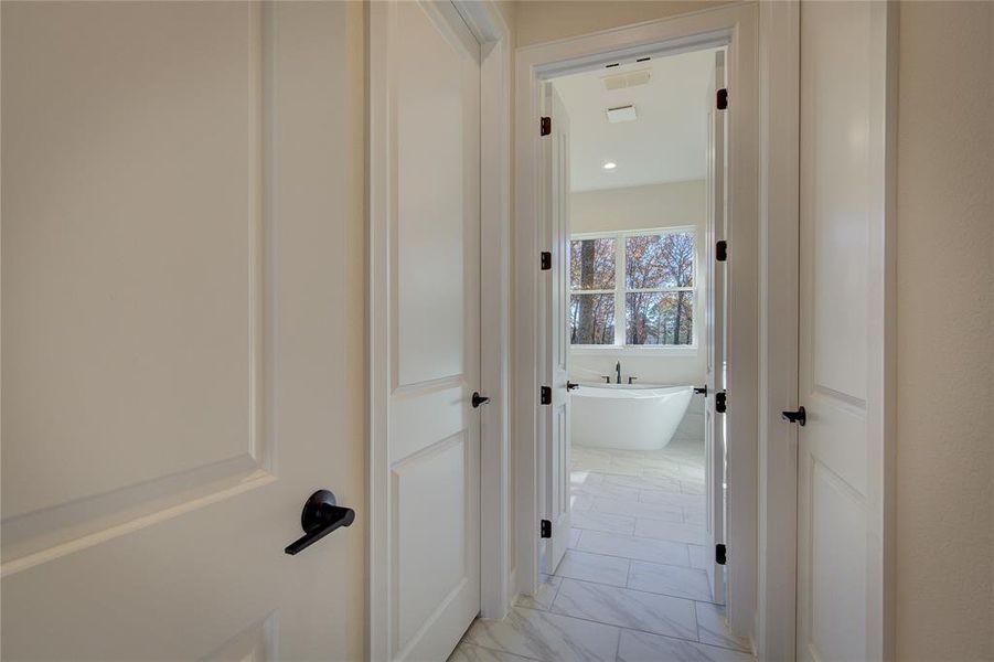 Between bedroom and bathroom are two huge his'n'hers walk-in closets with custom closet systems.
