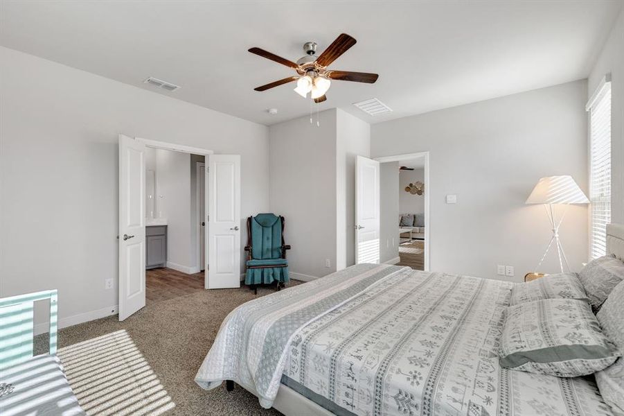 Bedroom featuring carpet and ceiling fan