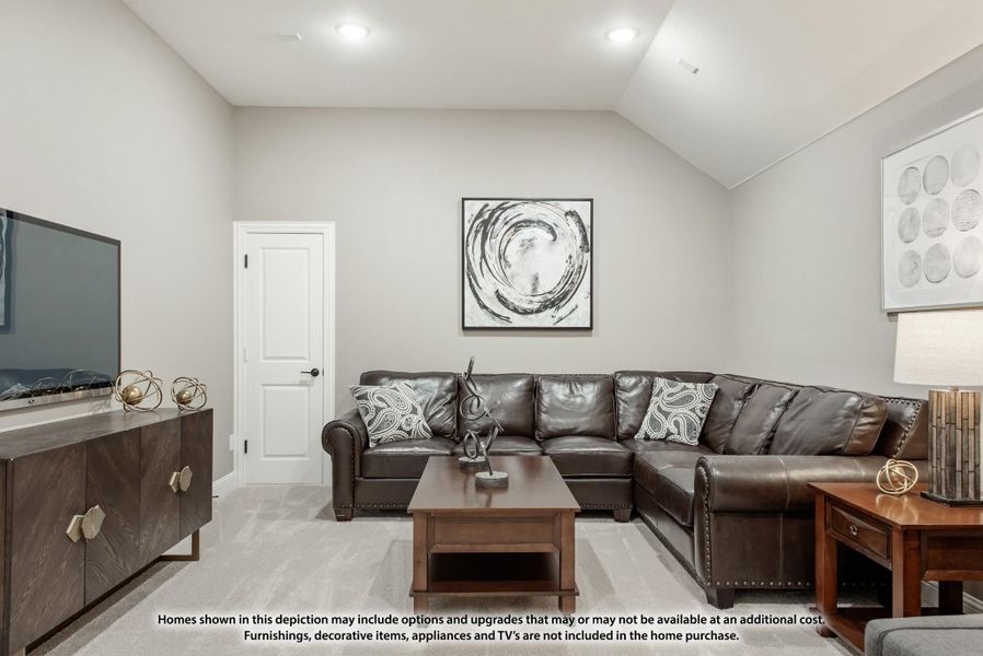 Living room with vaulted ceiling, dark leather sectional sofa, wood coffee table, and wall-mounted TV