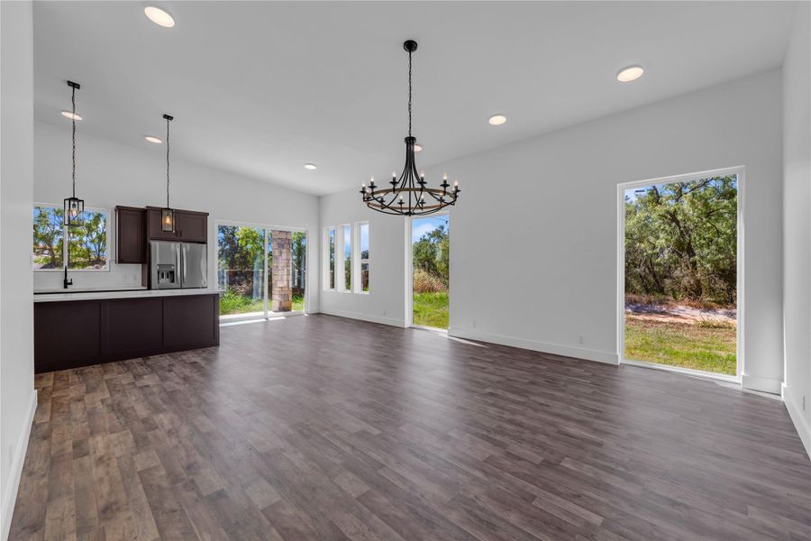 An airy open concept design features rich wood flooring and ample natural light.