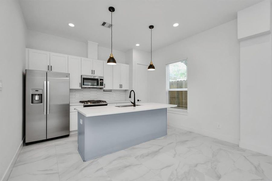 Enhance your culinary prowess in this spacious kitchen with an island providing ample workspace and storage for all your cooking needs.