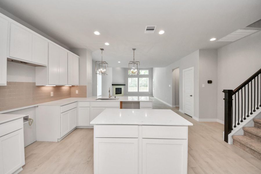 The open concept effortlessly connects the kitchen to the expansive family room, forming a perfect hub for gatherings. This seamless flow creates an inviting space where cooking and socializing come together harmoniously.