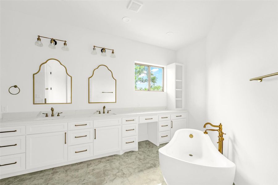 The owner’s bath features arched mirrors, a makeup vanity, and a vintage tub that add timeless character. The owner’s bath features arched mirrors, a makeup vanity, and a vintage tub that add timeless character.