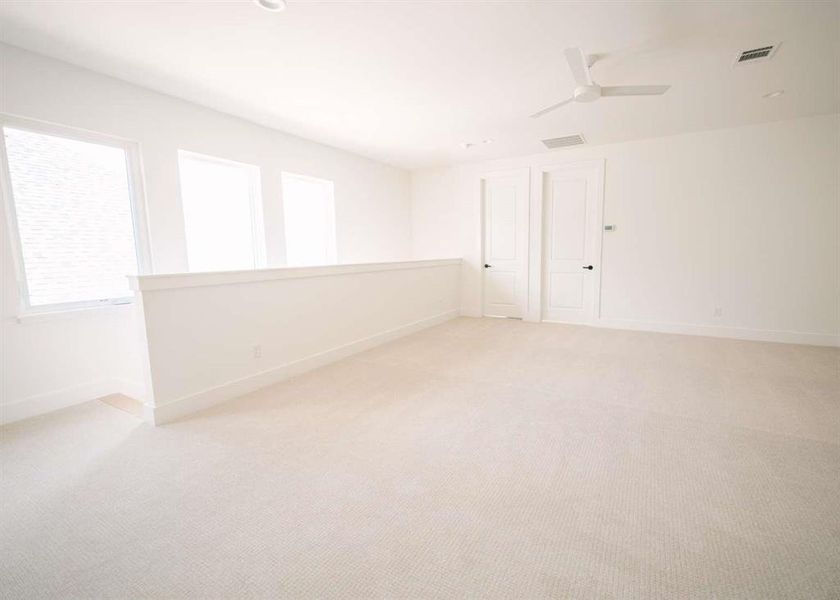 Spare room with carpet and ceiling fan