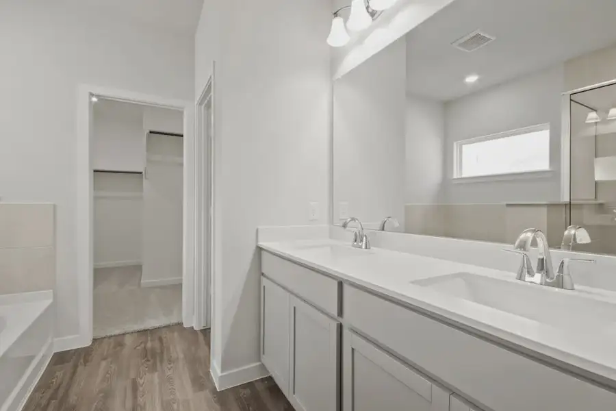 A bathroom with a large mirror.
