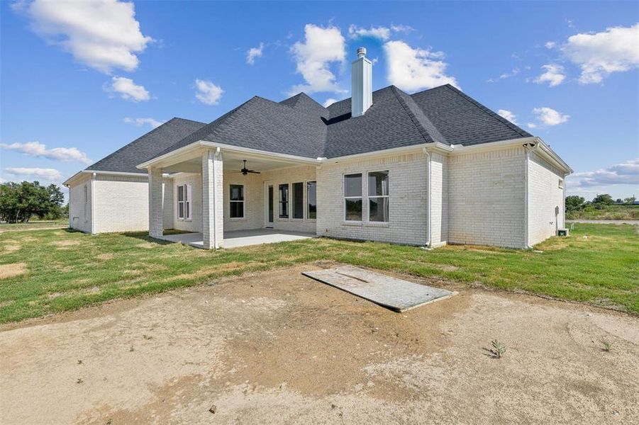 Back of house featuring a yard, a patio, and ceiling fan